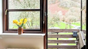 A window with a view of a green landscape and a wooden railing. - 1 bedroom accommodation in Newbridge-on-Wye, near Builth Wells (Newbridge-on-Wye, near Builth Wells)