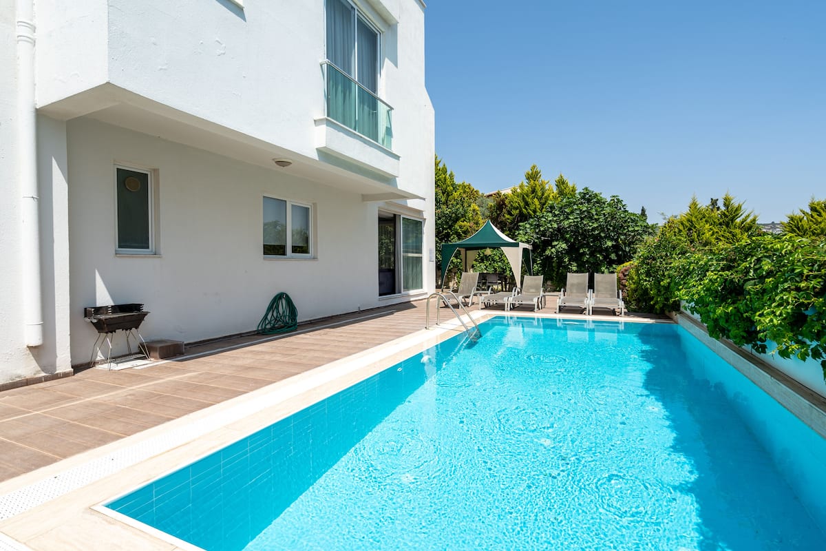 Ein Swimmingpool mit einem weißen Gebäude im Hintergrund.