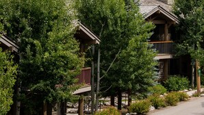 A lodge with a wooden exterior, multiple balconies, and a view of a forested hillside. - Outpost: Grand View 491 - Air Conditioning (Jackson)