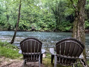 Two Adirondack chairs facing a river in a forested area. - Relax & Unwind at the Chestatee River Retreat! Pet Friendly & Near Wineries (Dahlonega)