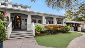 A building with a porch, steps, and a sign that reads "Old Florida Fish House."