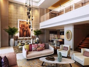Experience the grandeur of our lobby, featuring a soaring ceiling, comfortable seating area, and a stunning staircase.