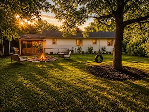 A house with a covered patio, a fire pit, and outdoor seating. - Charming Asheville Cottage: HotTub+ Fire pit.Great Location! Near DT & Biltmore. (Asheville)