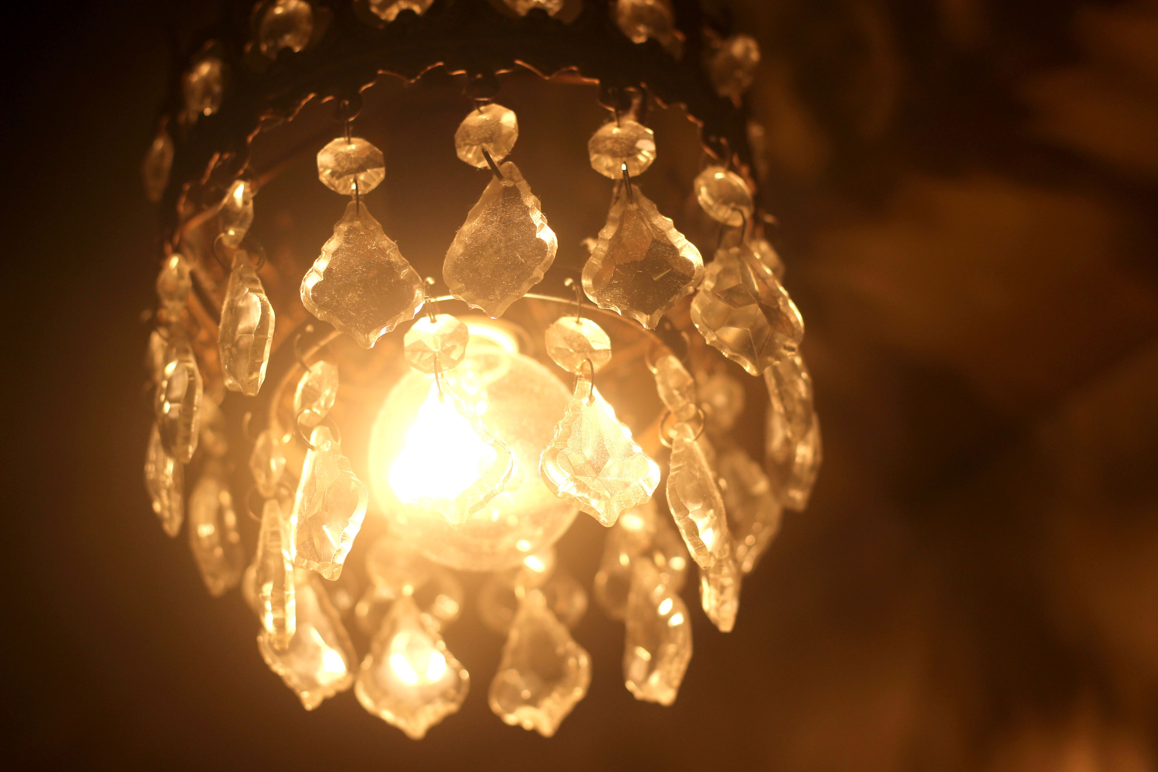 A chandelier with multiple crystal-like elements and a central light source.