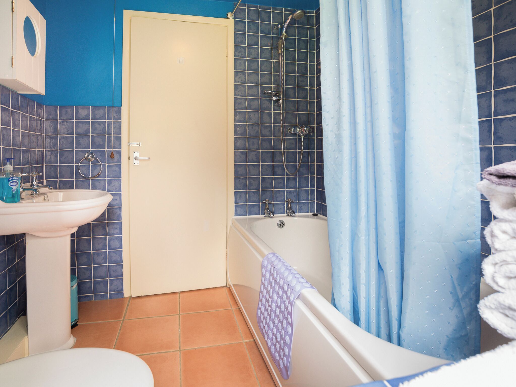 A bathroom with a sink, toilet, bathtub, and shower.