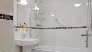 A modern bathroom with a glass-enclosed shower, a white sink, and a bathtub. - James' Retreat (was12 Elm Court) (Keswick)
