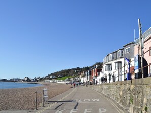 A coastal promenade with a pebbled beach, a stone wall, and buildings along the shore. - 2 bedroom accommodation in Cerne Abbas, near Dorchester (Cerne Abbas, near Dorchester)