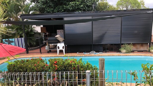 A swimming pool surrounded by greenery, a covered outdoor area with a table and chairs, and a fenced garden area. - Close to amenities, NBN, Swimming pool, Netflix,  (Kirwan)