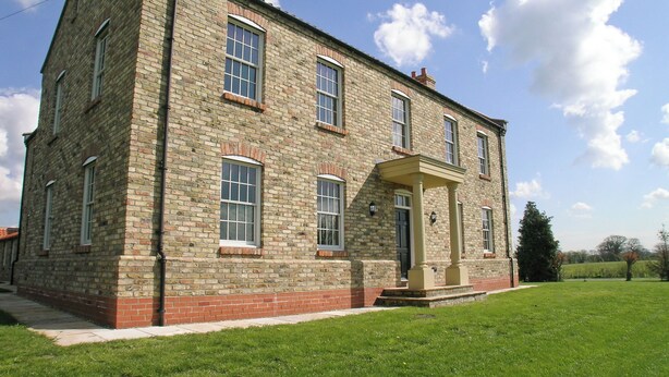 A two-story stone building with a symmetrical facade, a central entrance with a porch, and a well-maintained lawn in front. - 7 bedroom accommodation in Holme-on-Spalding Moor, near Market Weighton (Holme-on-Spalding Moor, near Market Weighton)