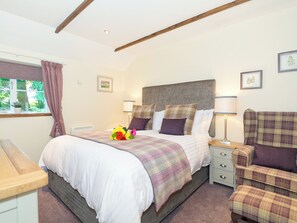 A bedroom with a bed, bedside tables, a chair, and a window with curtains. - 1 bedroom accommodation in Thornton le Dale near Pickering (Thornton le Dale near Pickering)