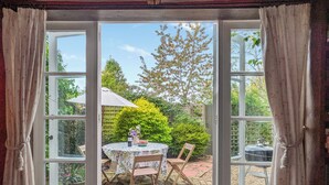 A room with a large glass door leading to an outdoor patio area. - 2 bedroom accommodation in Halesworth (Halesworth)
