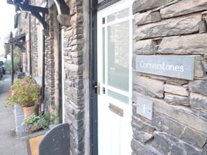 A stone building with a sign reading "Cornerstones" and a door number "1". - 3 bedroom accommodation in Ambleside (Ambleside)