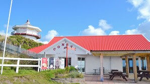 A building with a red roof and a sign that reads "CONSTELLATION". - Cliff Railway Apartment (Aberystwyth)