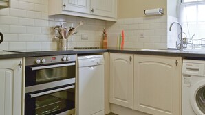 A kitchen with white cabinets, a Bosch dishwasher, a double oven, and a washing machine. - 3 bedroom accommodation in Snettisham, near Hunstanton (Snettisham, near Hunstanton)