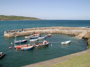 A harbor with several boats docked at a stone pier. - 3 bedroom accommodation in Coverack, near Helston (Coverack, near Helston)