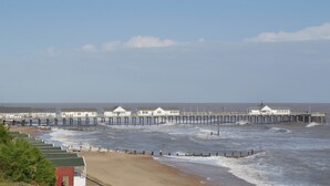 A pier with several white buildings, a sandy beach, and the ocean. - 2 bedroom accommodation in Woodbridge (Woodbridge)
