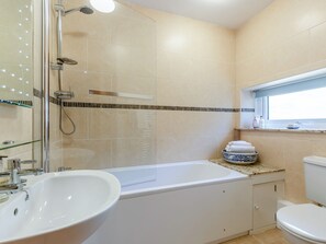 A bathroom with a shower, sink, bathtub, and toilet. - New Park Farm - Church Cottage (near Keswick)