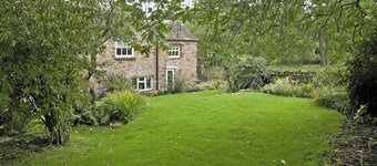 A spacious detached cottage located by a beck in a quiet village.