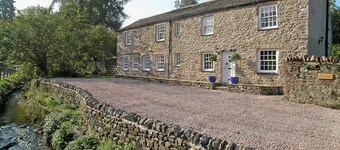 A spacious detached cottage located by a beck in a quiet village.