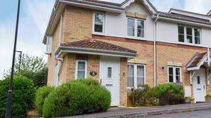 A two-story residential building with a brick facade, white windows, and a tiled roof. - 3 bedroom accommodation in East Cowes (East Cowes)