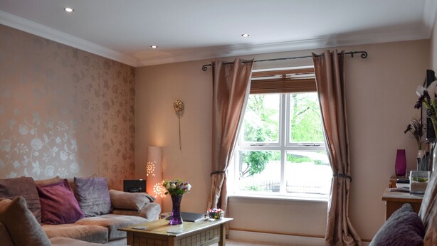 A living room with a sofa set, a coffee table, and a window with curtains. - 3 bedroom accommodation in York (York)