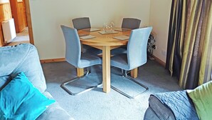 A dining area with a round table, four chairs, and a glass on the table. - 3 bedroom accommodation in Strachan, near Banchory (Strachan, near Banchory)