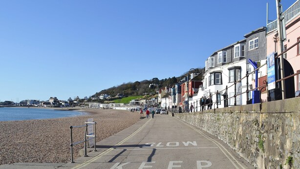 A coastal promenade with a pebble beach, a 'SLOW KEEP' road marking, and buildings along the promenade. - 2 bedroom accommodation in Wootton Fitzpaine, near Charmouth (Wootton Fitzpaine, near Charmouth)