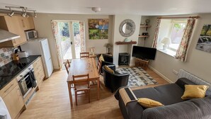 A compact living space with a kitchenette, dining area, and seating area.