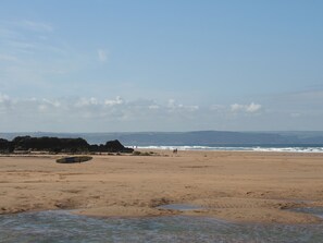 A beach with a clear sky, rocky outcrops, and a calm sea. - 1 bedroom accommodation in Hartland, near Bideford (Hartland, near Bideford)