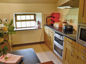 A kitchen with wooden cabinets, a stove, and a window. - 3 bedroom accommodation in Blawith, near Coniston (Blawith, near Coniston)