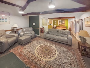 A living room with a patterned rug, leather sofas, and a dining area in the background. - 3 bedroom accommodation in Blawith, near Coniston (Blawith, near Coniston)
