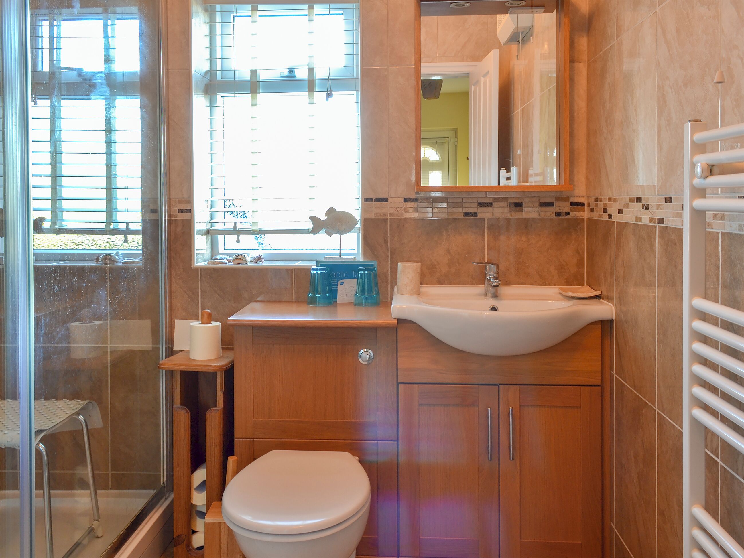 A bathroom with a toilet, sink, and shower area.