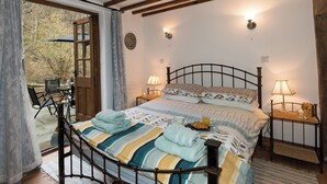 Un dormitorio con cama, lámparas de noche y vistas al exterior.