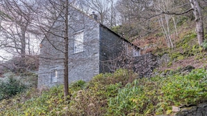 A stone wall with a stone building in the background. - Super location within woodland and a SSSI. (Glenridding, near Penrith)