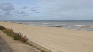 A wide sandy beach with a clear sky and calm sea. - 3 bedroom accommodation in Walcott (Walcott)