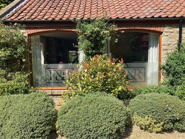 A building with a tiled roof, a large window with a metal frame, and a sign with "&R" visible. - All on the Ground Floor:
Open plan living space. (Lockton, near Pickering)