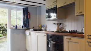 A kitchen with white cabinets, a microwave, a stove, and a dishwasher.