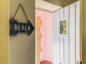 A wall-mounted sign with the word 'BEACH' and a door with a window. - 4 bedroom accommodation in Bothenhampton, near Bridport (Bothenhampton, near Bridport)