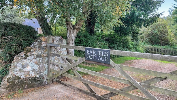 A wooden gate with a sign reading "BARTERS COTTAGE" leading to a stone wall and a pathway. - 2 bedroom accommodation in North Chideock, near Bridport (North Chideock, near Bridport)