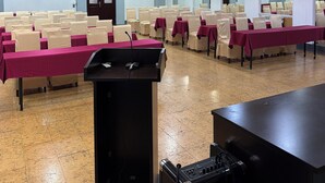 A conference room with rows of chairs, a podium, and a sound system. - Royal Hotel (Baku)