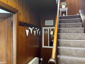 A wooden interior with a staircase, a sign reading 'THIS IS OUR HAPPY PLACE', and triangular decorations. - 3 bedroom accommodation in Kilmichael Glassary, near Lochgilphead (Kilmichael Glassary, near Lochgilphead)