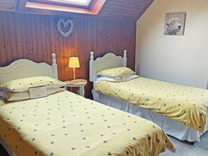 A room with two beds, a small table with a lamp, wooden walls, and a picture on the wall. - 3 bedroom accommodation in Kilmichael Glassary, near Lochgilphead (Kilmichael Glassary, near Lochgilphead)