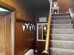 A wooden interior with a staircase, a sign reading 'THIS IS OUR HAPPY PLACE', and triangular decorations. - 3 bedroom accommodation in Kilmichael Glassary, near Lochgilphead (Kilmichael Glassary, near Lochgilphead)