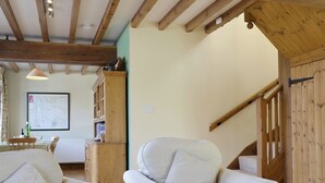 A room with wooden beams, a staircase, and a dining area with a map on the wall. - 3 bedroom accommodation in near Easingwold (near Easingwold)