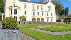 A large, cream-colored building with multiple windows and a symmetrical facade. - 1 bedroom accommodation in Salem, near Llandeilo (Salem, near Llandeilo)