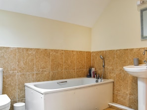 A bathroom with a bathtub, a sink, and a toilet.