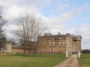 A large, historic building with a symmetrical facade, large windows, and a central entrance.