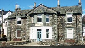 A stone building with a sign reading "Harney Peak." It has a traditional architectural style with a pitched roof and multiple chimneys. - 2 bedroom accommodation in Portinscale, near Keswick (Portinscale, near Keswick)