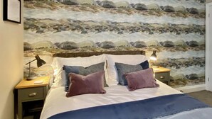A bedroom with a large bed, two bedside tables, and a wall mural. - 2 bedroom accommodation in Portinscale, near Keswick (Portinscale, near Keswick)