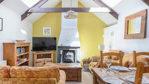 A cozy living room with a fireplace, wooden furniture, and a television. - 2 bedroom accommodation in St Breward, Bodmin Moor (St Breward, Bodmin Moor)